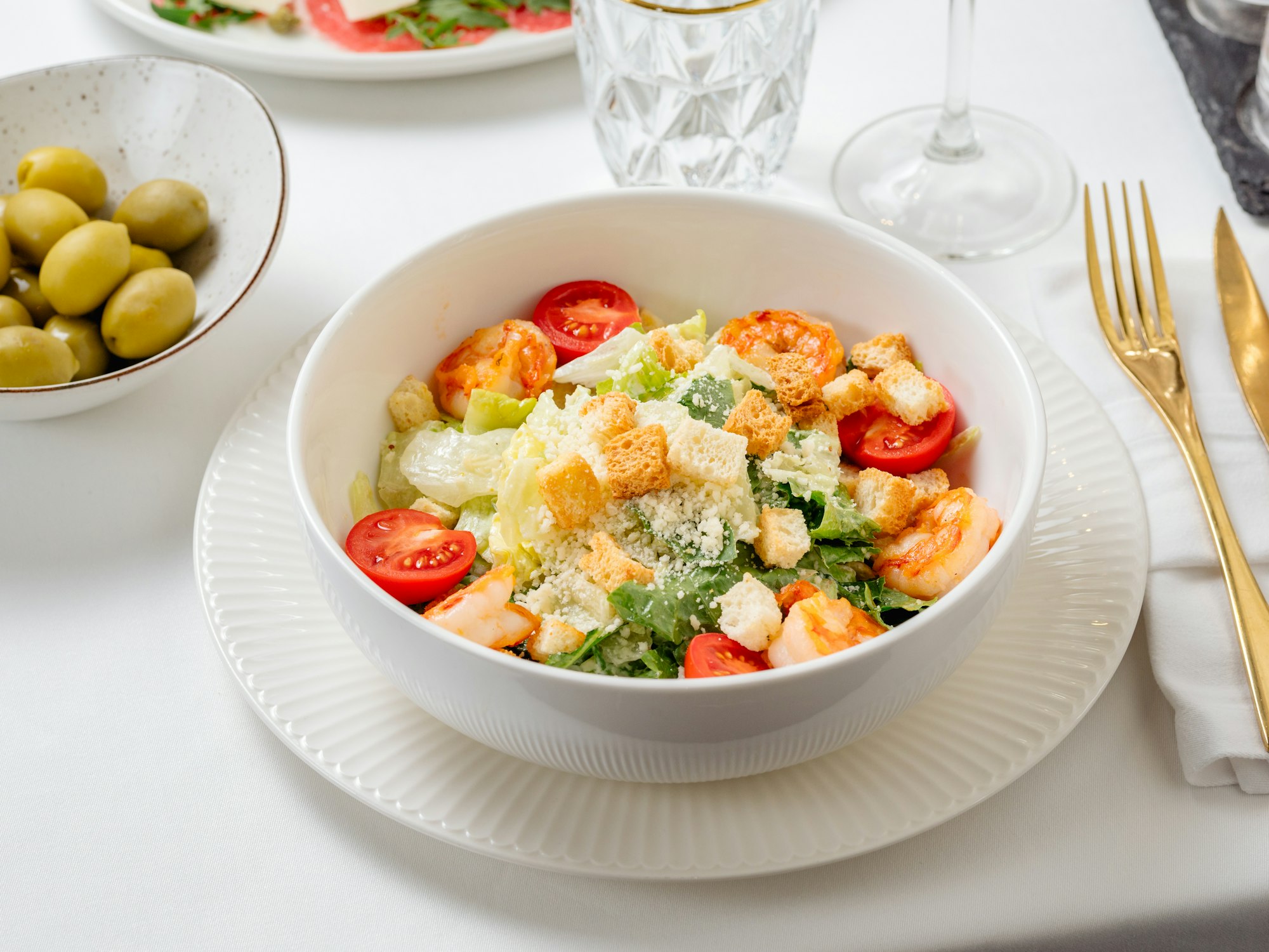 Caesar salad with shrimps on restaurant table
